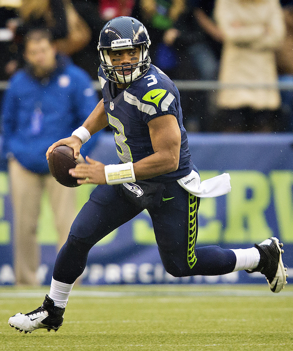 Seattle Seahawks quarterback Russell Wilson holds up the Vince